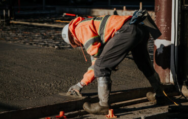 workers construction site laying pavement