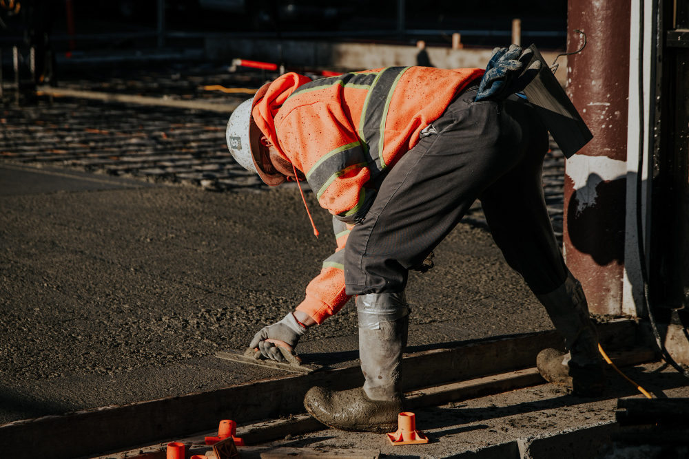 workers construction site laying pavement